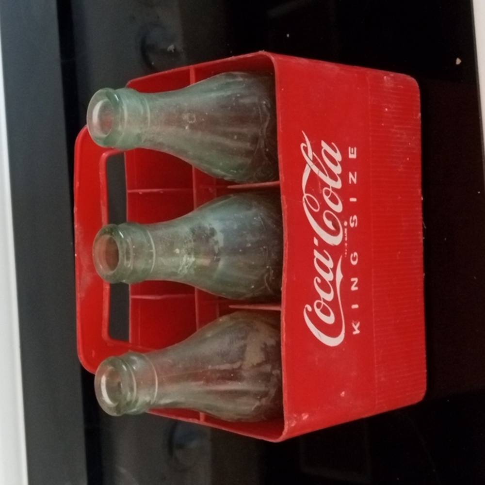 6 pack plastic coke carry case and 3 vintage bottles